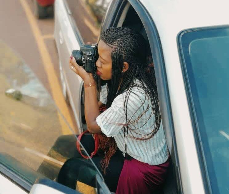 Blessing attempts to take a photo at the Uganda Museum, 2017.
